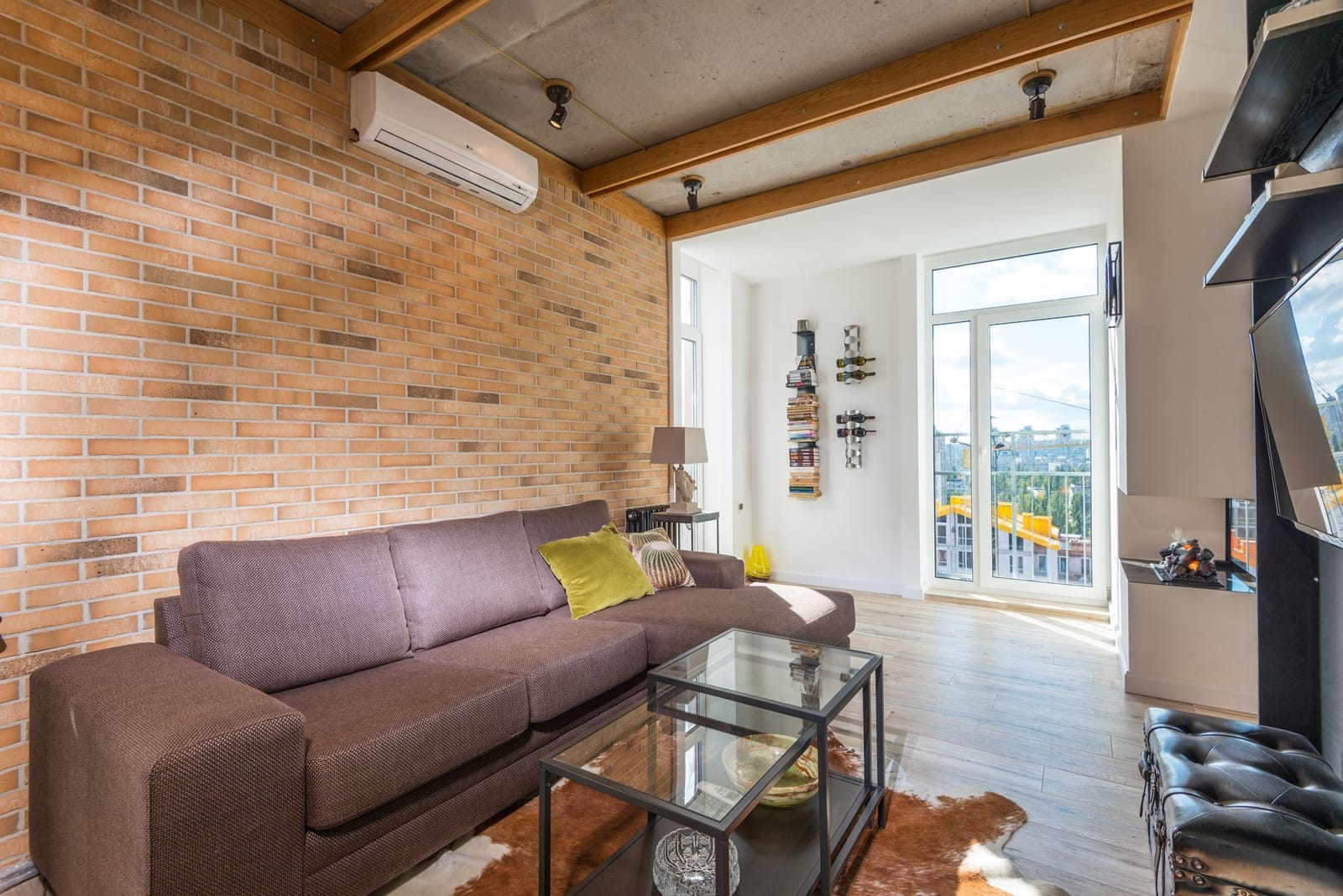 An external air-to-air heat pump condenser unit on the brick wall of a UK home